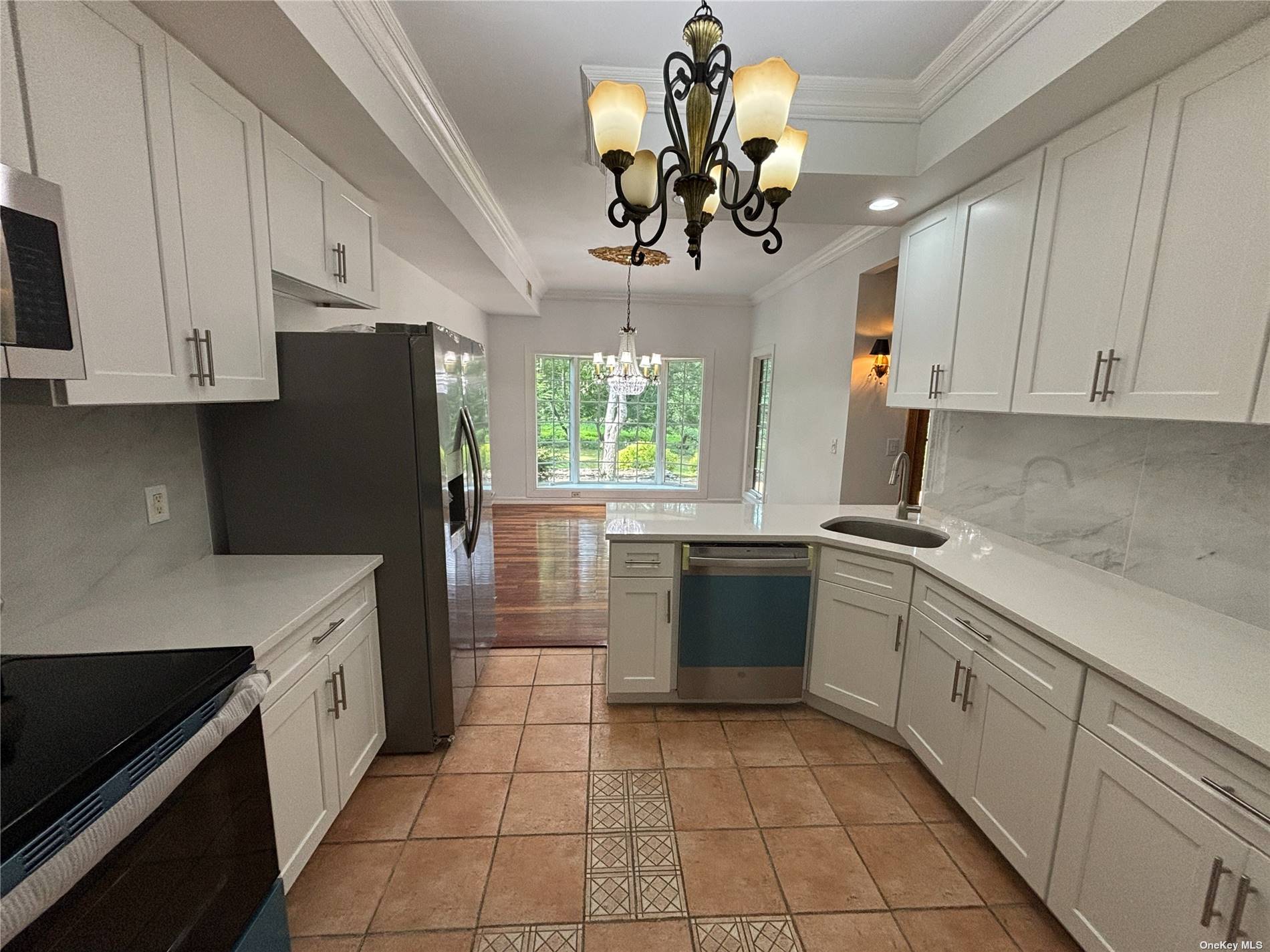 a kitchen with a refrigerator and a sink