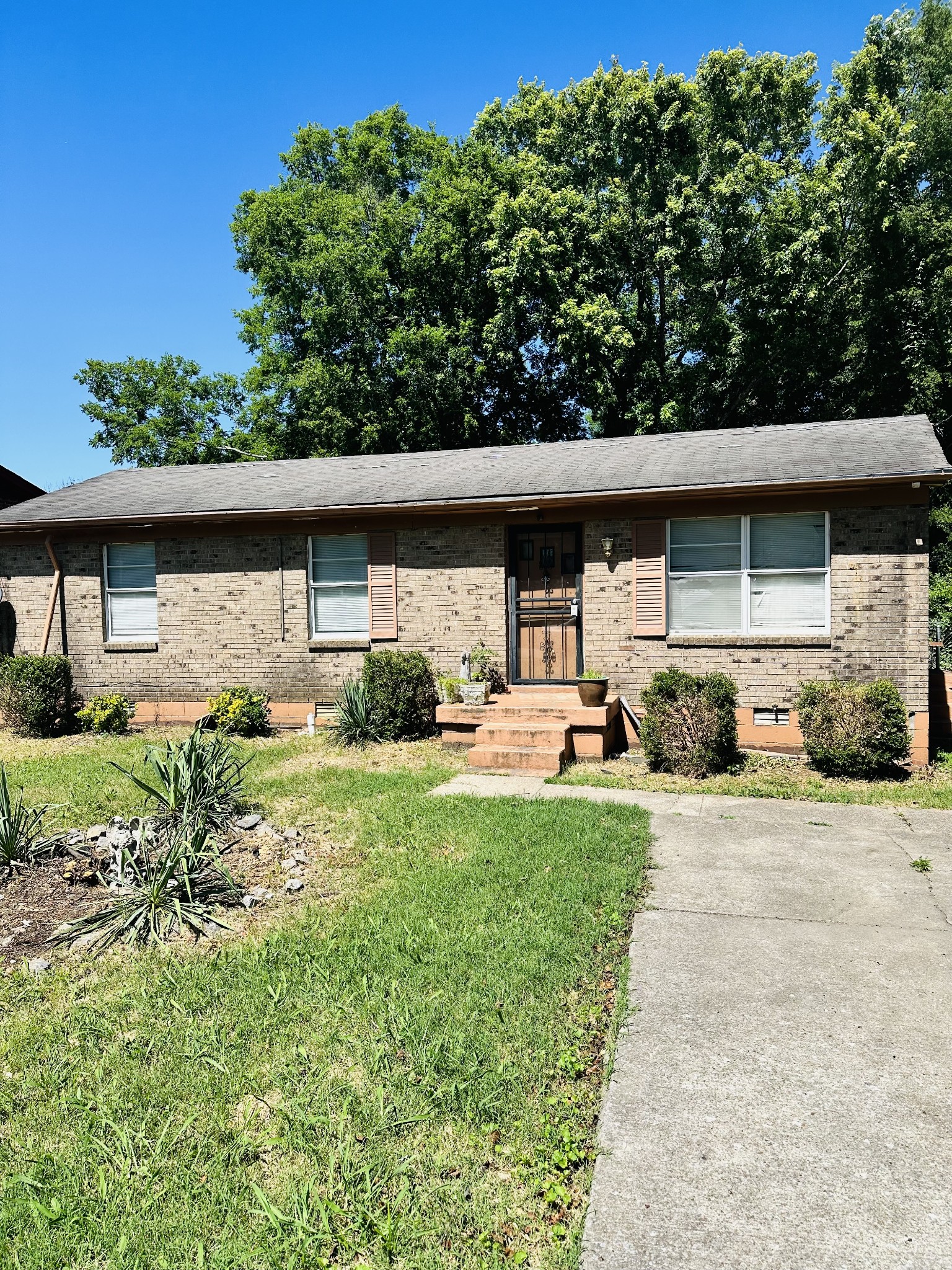 a front view of a house with garden