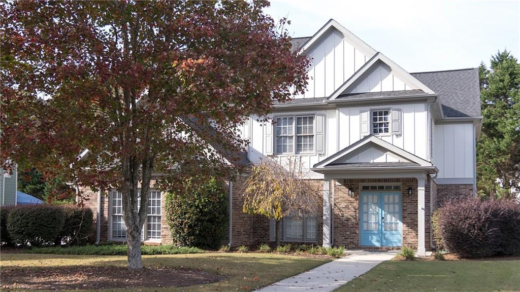 a front view of a house with a garden