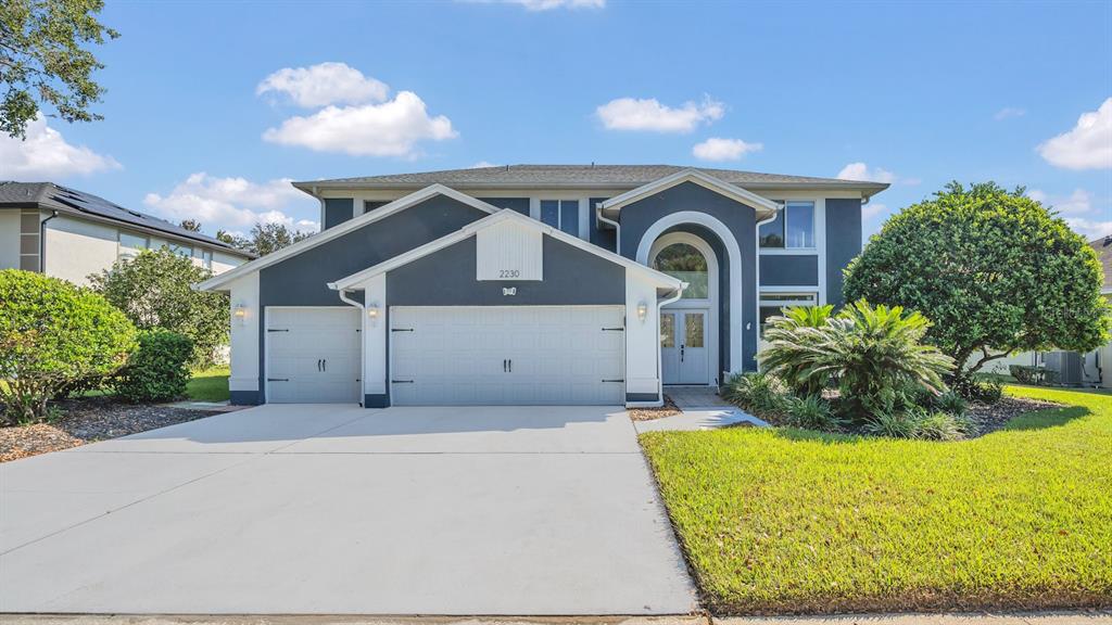 a front view of a house with a yard and garage