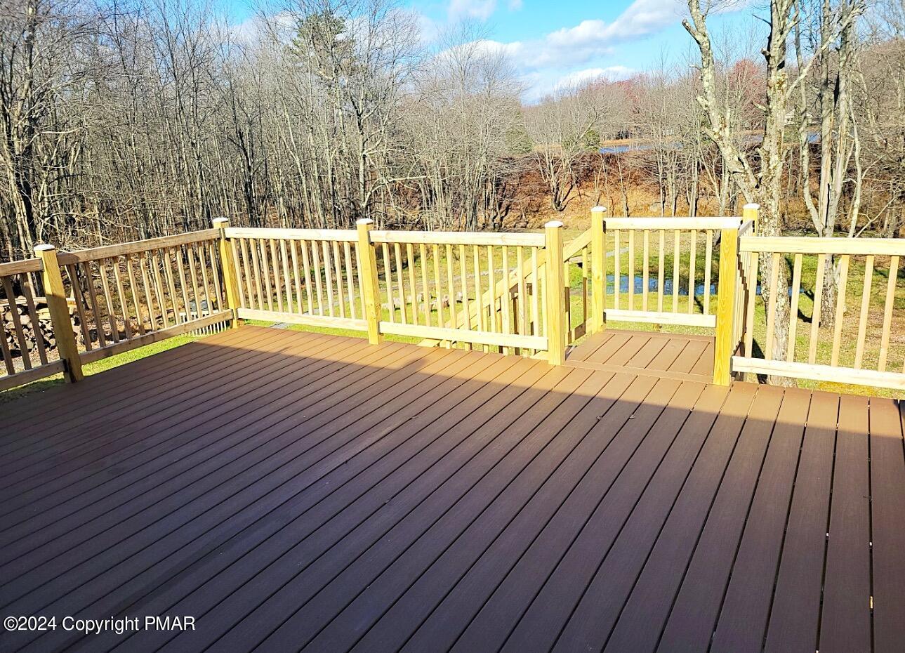 a view of a wooden deck with a yard