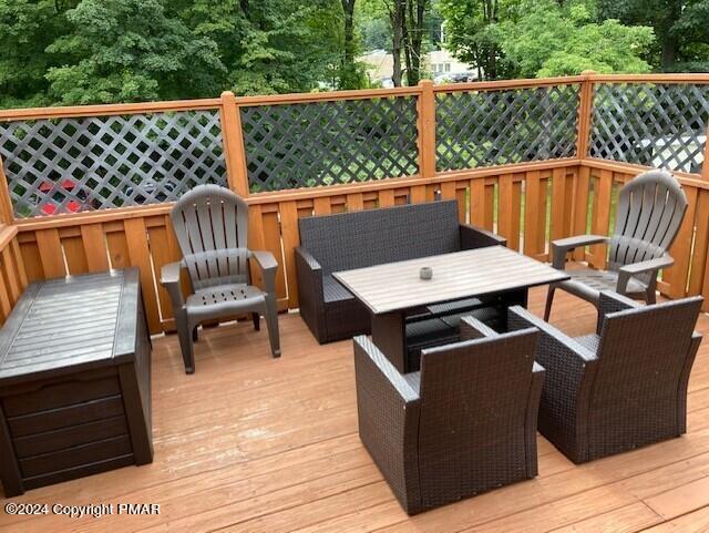 a view of a roof deck with wooden floor and outdoor seating