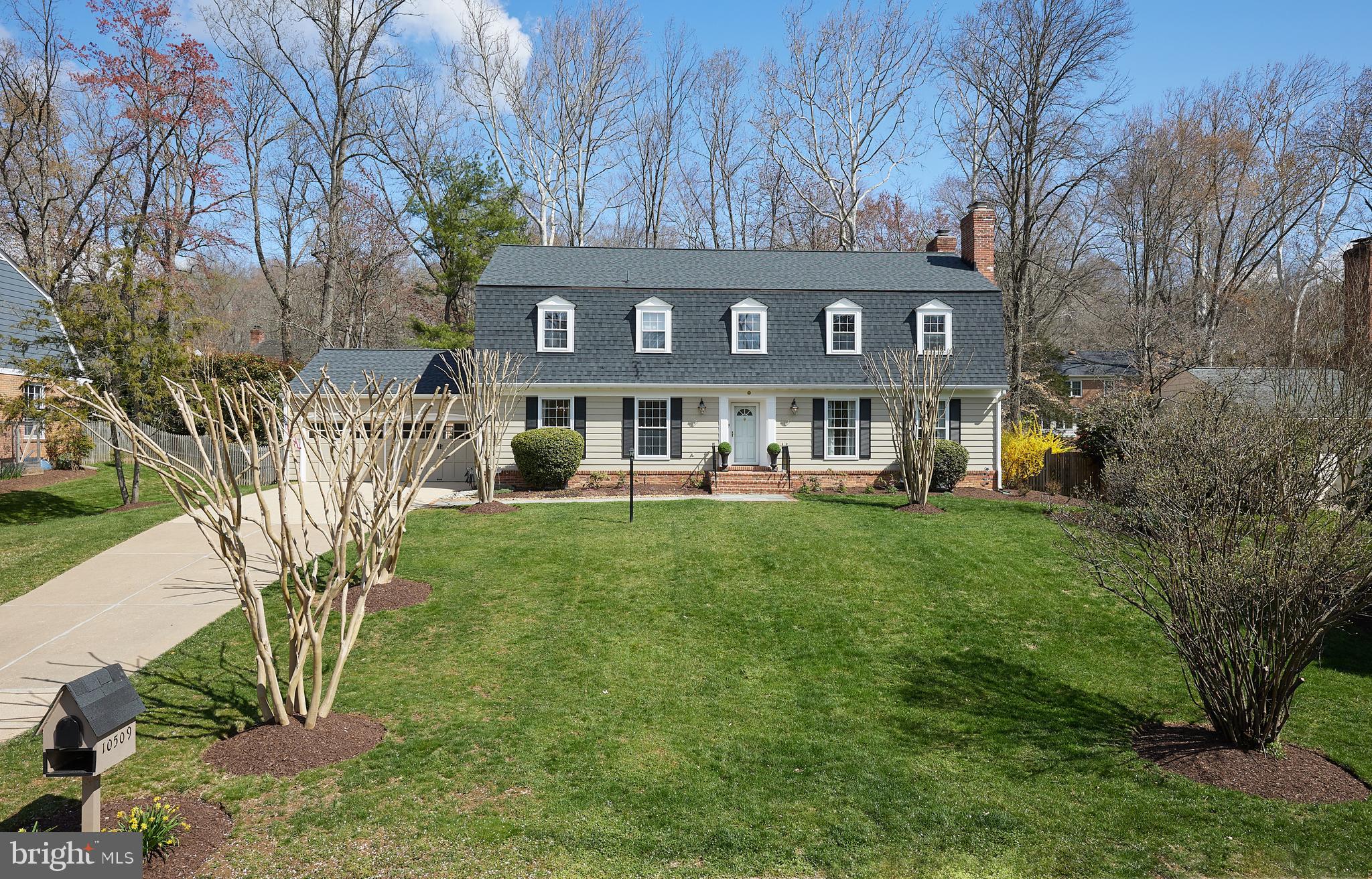 a front view of residential houses with yard and green space