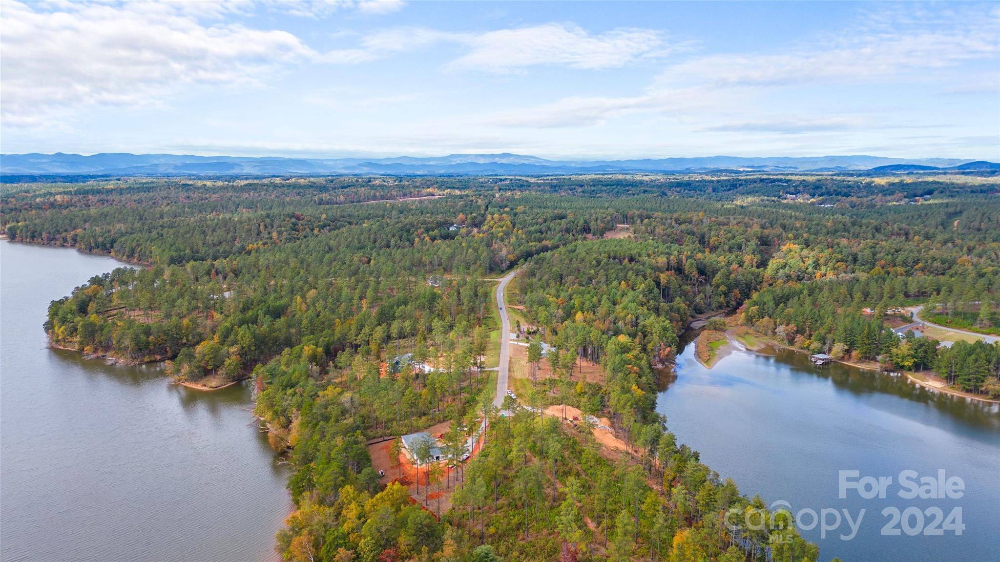 an aerial view of lake and residential houses with outdoor space