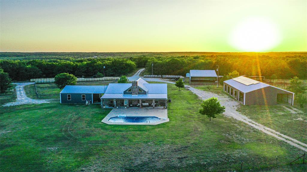 an aerial view of a house with outdoor space swimming pool