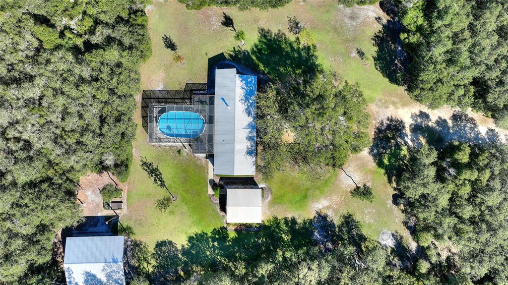 an aerial view of a house with swimming pool