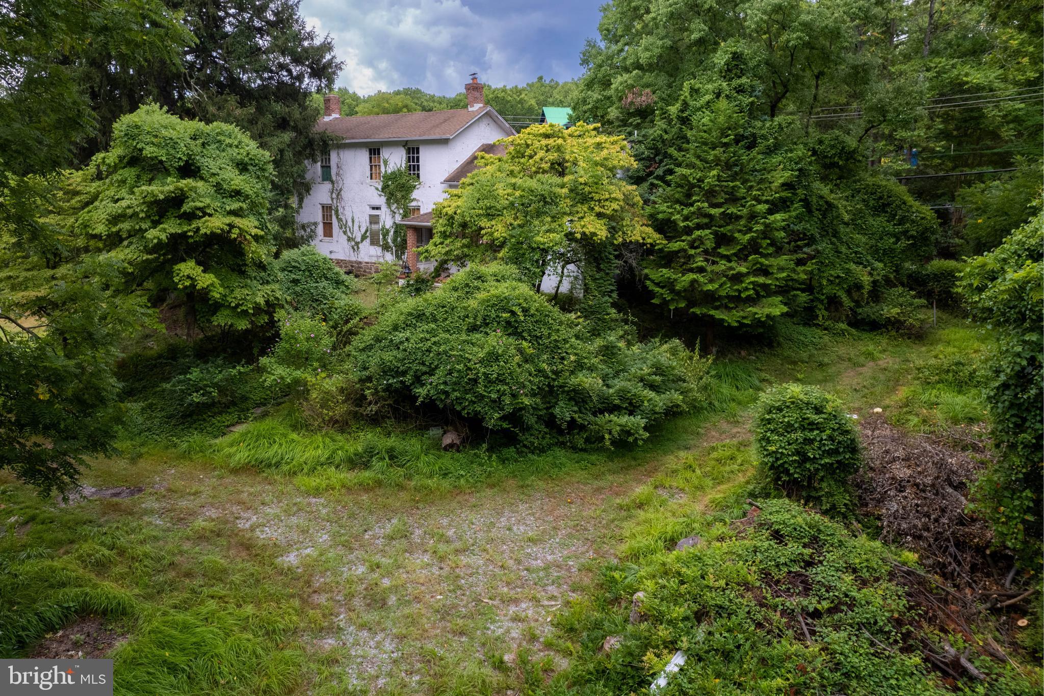 an aerial view of a house with a yard and garden