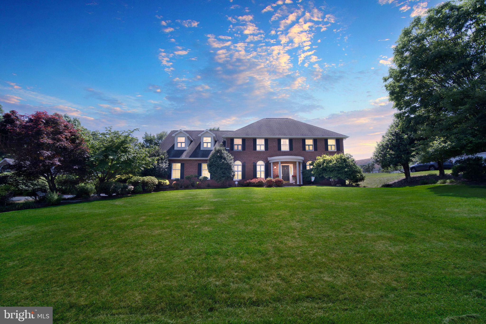 a view of a big yard with a house in the background