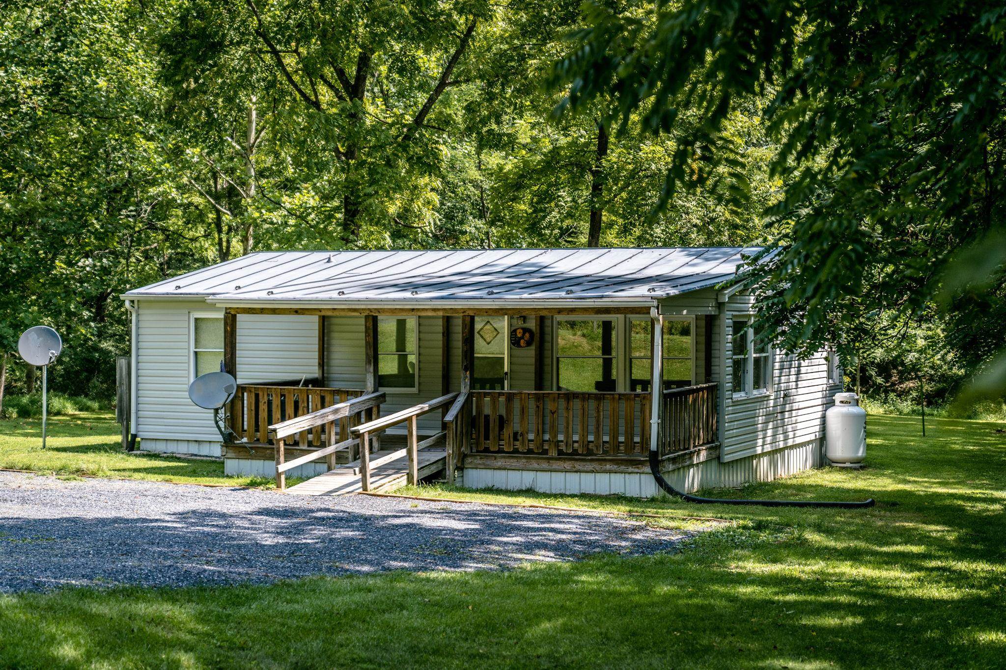 a view of a house with backyard porch and sitting area