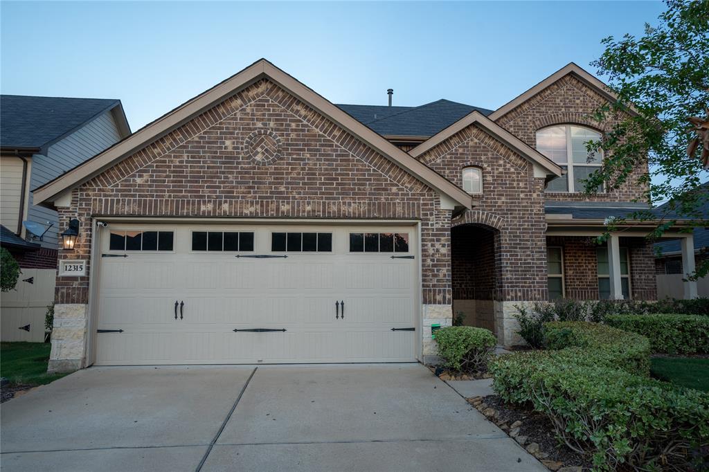 a front view of a house with garage