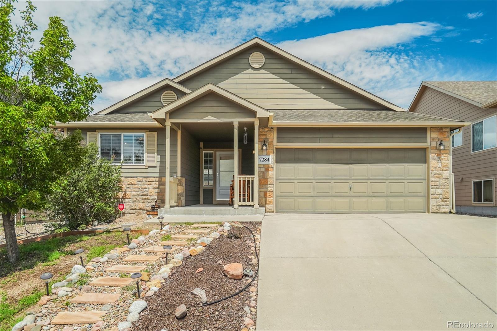 a front view of a house with a yard and garage