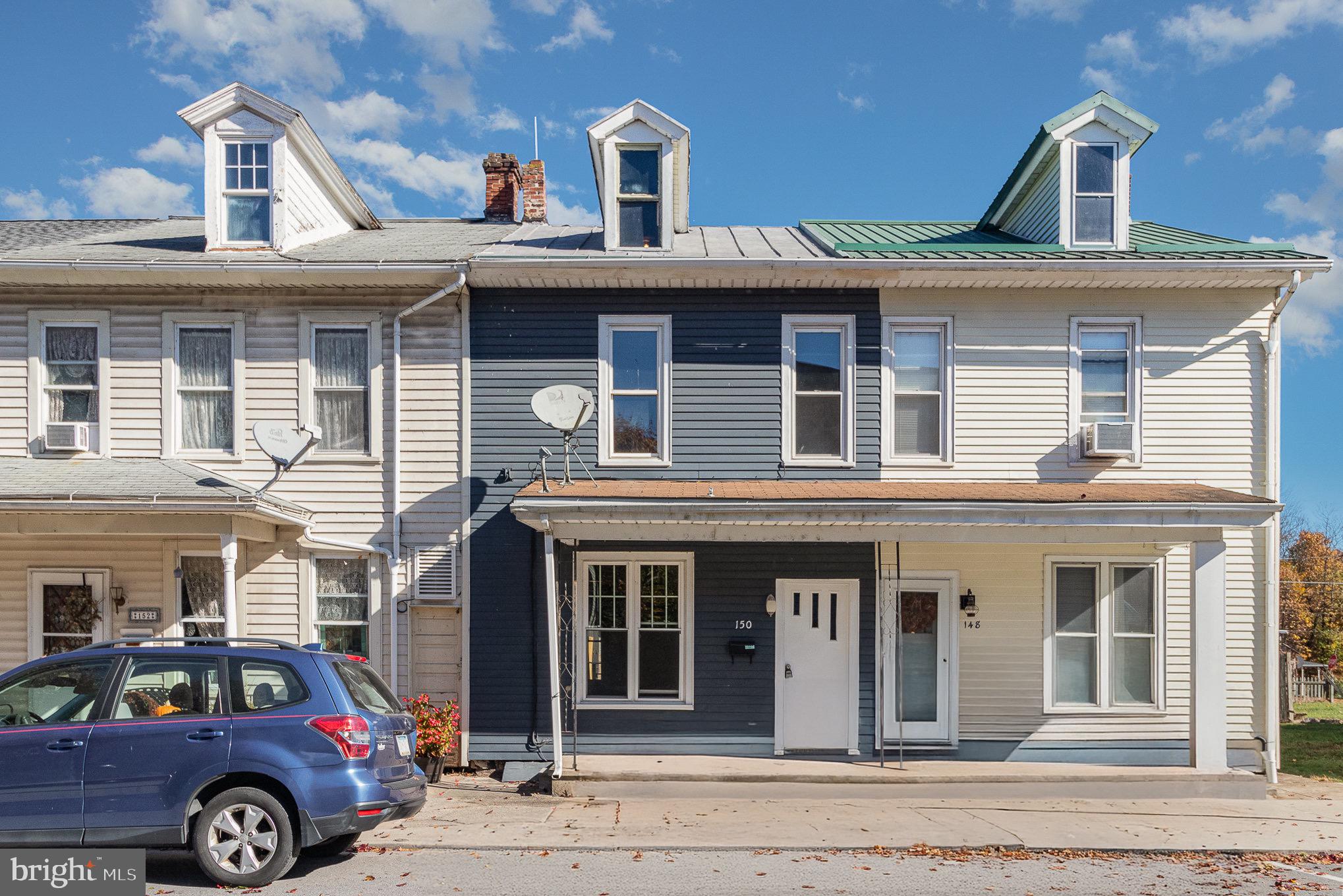 a front view of a house with parking space