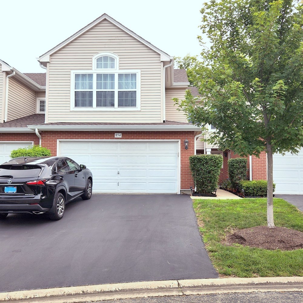 a view of a car park in front of house