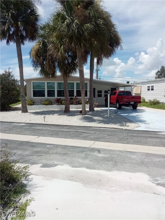 a view of a car park front of house