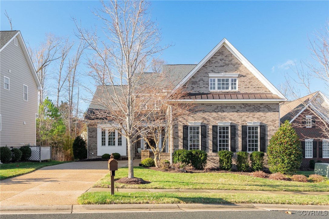 Beautiful brick facade with hardiplank siding acce