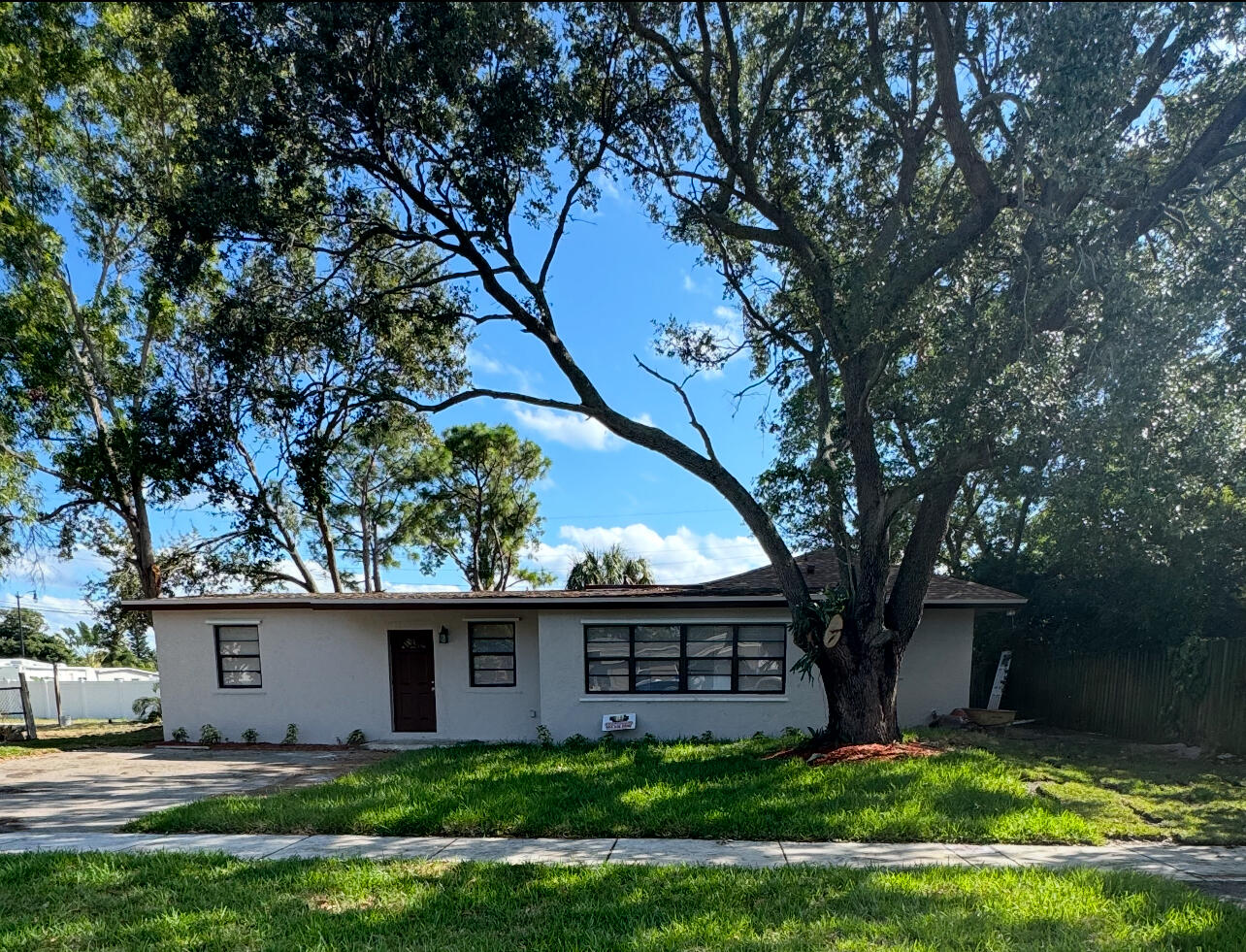 a view of house with backyard