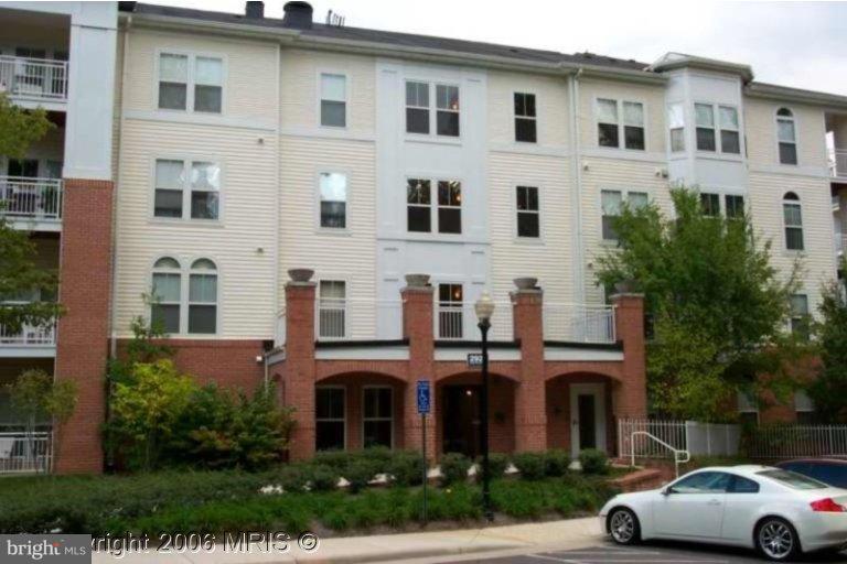 a front view of a residential apartment building with a yard