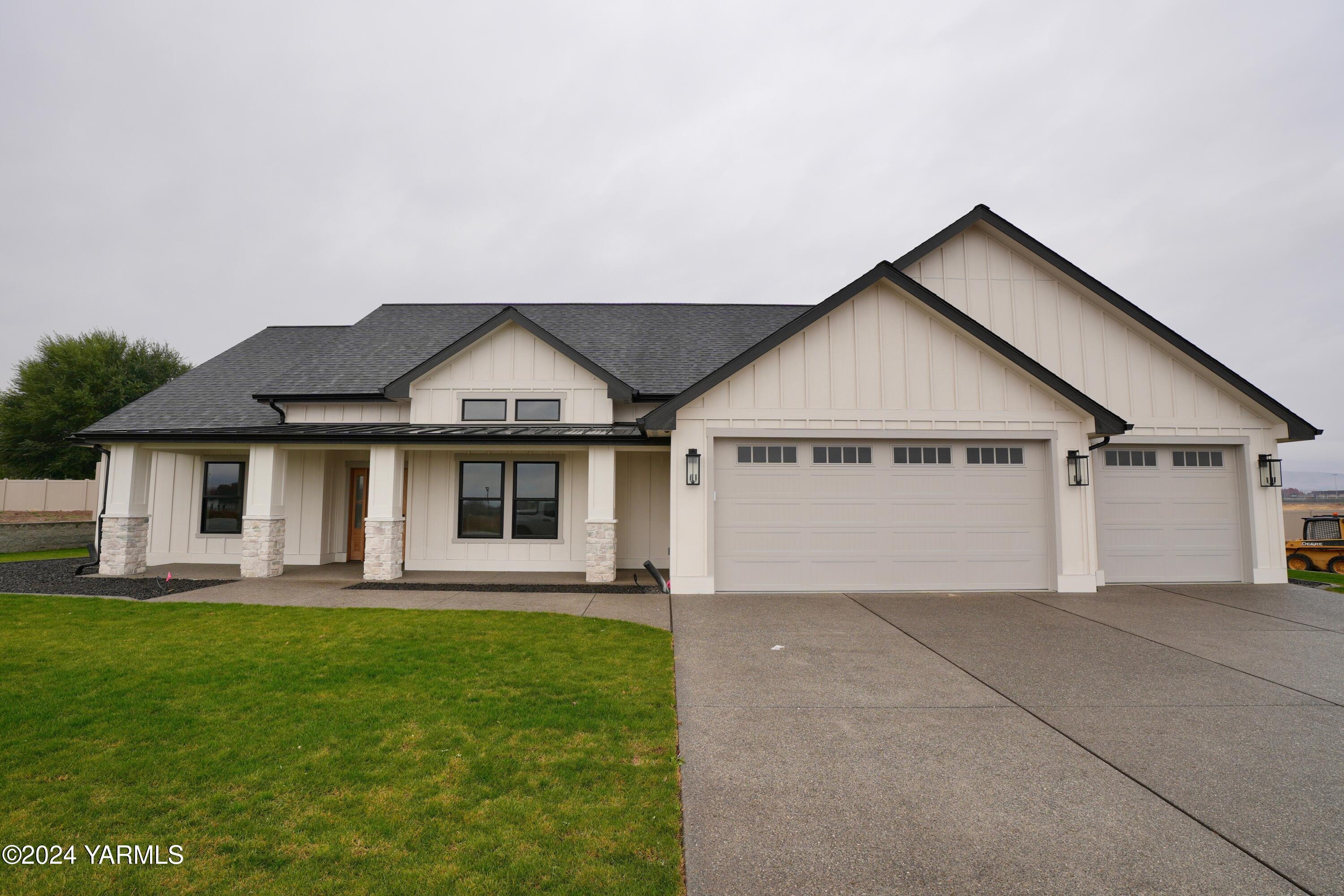 a view of a house with a yard and garage