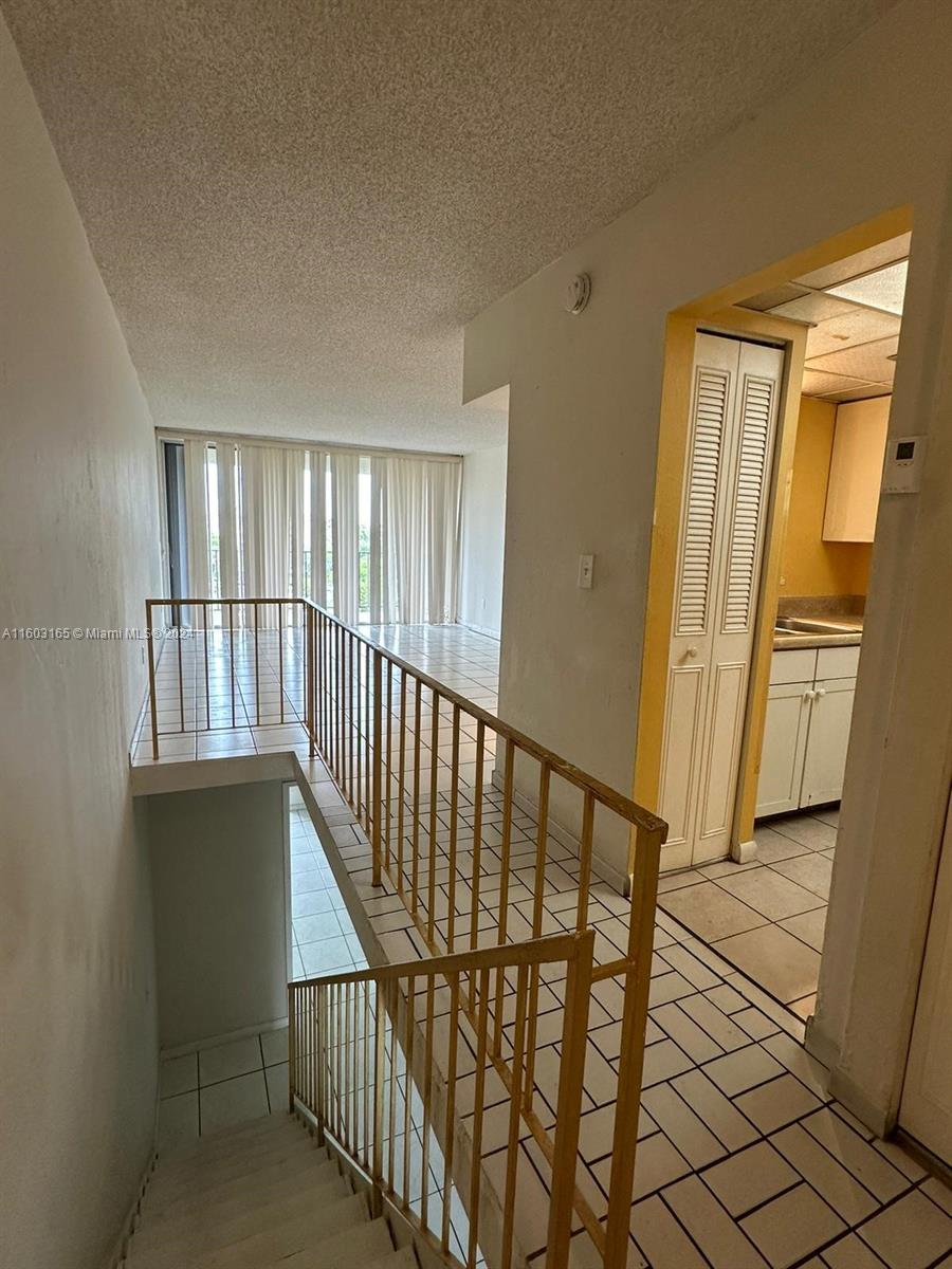 a view of staircase with lots of wooden floor and windows