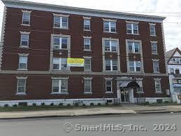 a view of a brick building with many windows