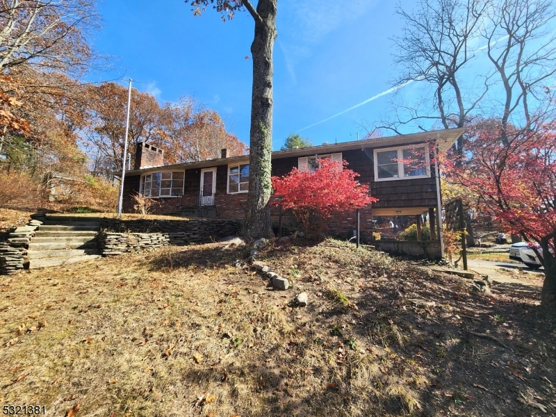 a front view of a house with a yard covered in snow