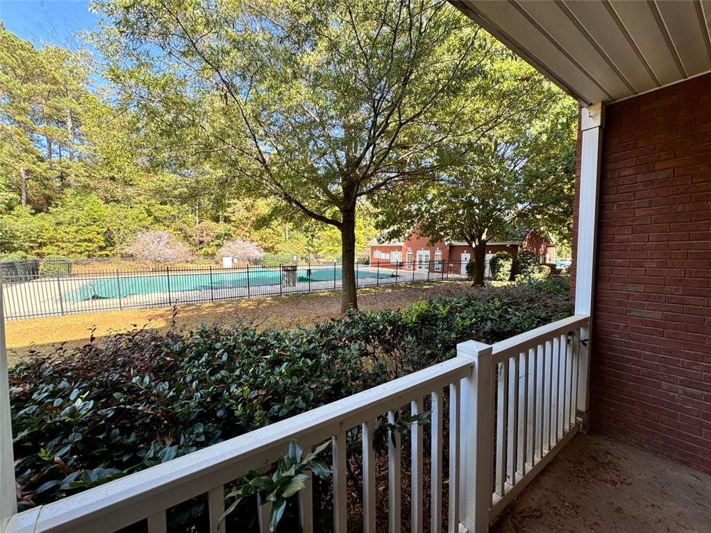 a view of a balcony with trees in front of it