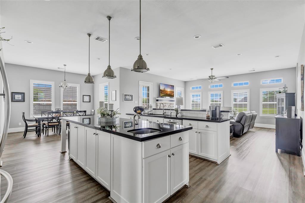 a kitchen with counter space sink stove and wooden floor