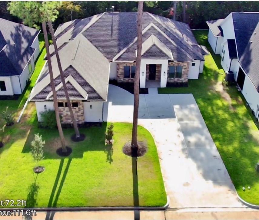 a aerial view of a house with a yard