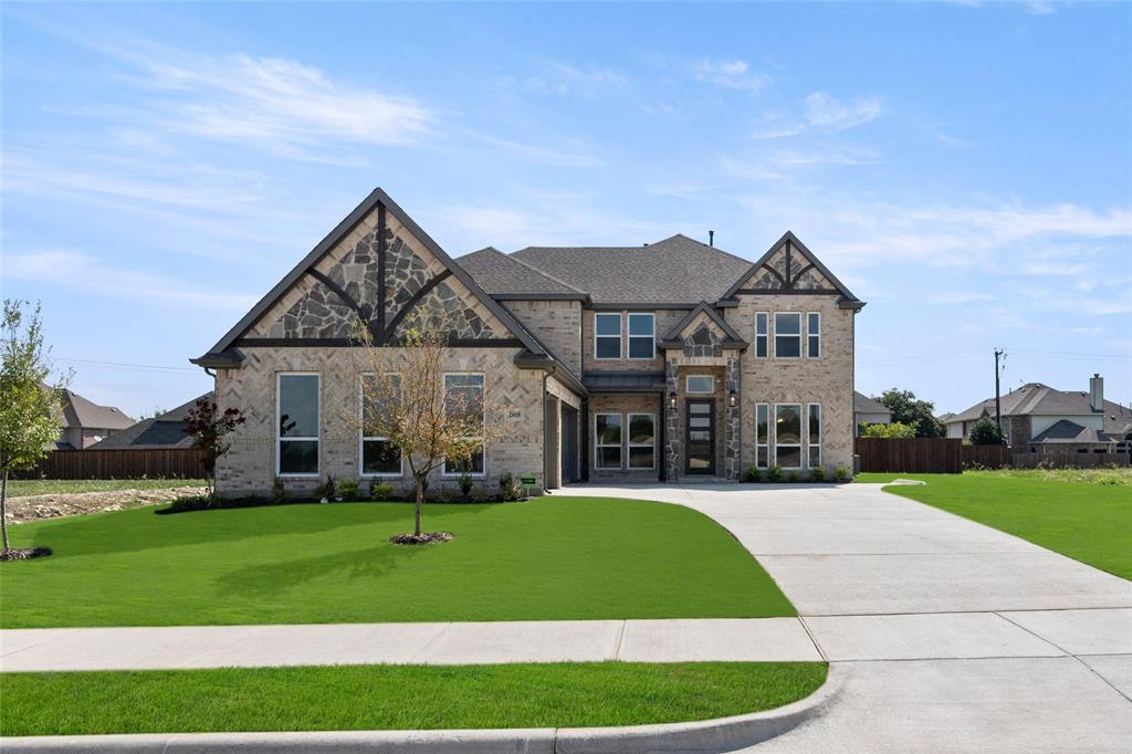 a view of a big house with a big yard and potted plants in front of the house