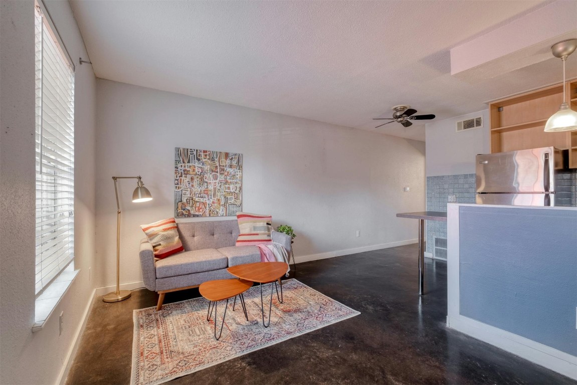 a living room with furniture and a potted plant