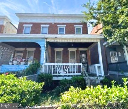 a view of a brick house with a yard