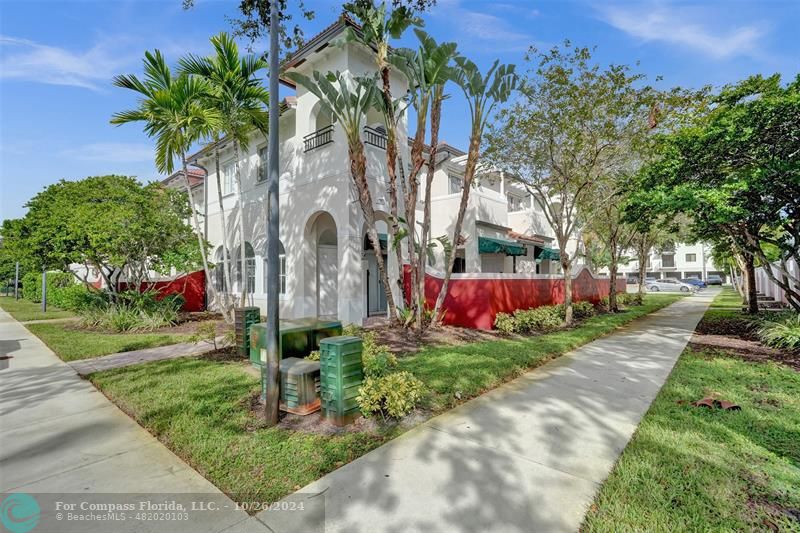 a front view of a house with a yard and potted plants