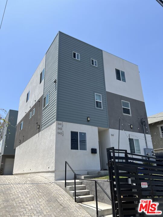 a front view of a building with table and chairs