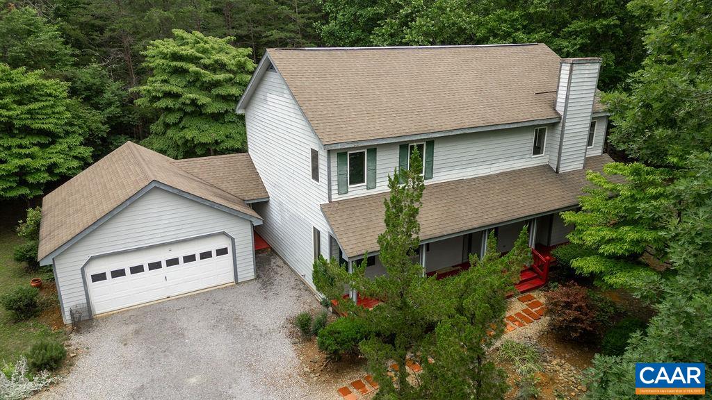 a aerial view of a house with a yard and potted plants