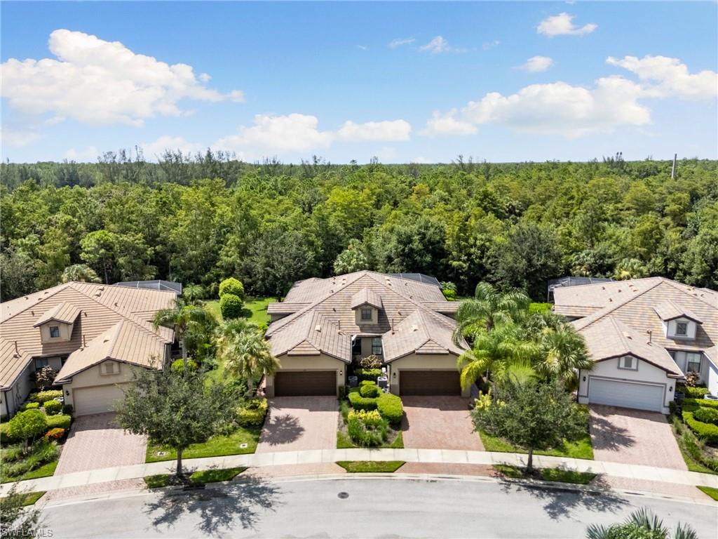 an aerial view of a house with garden space and street view