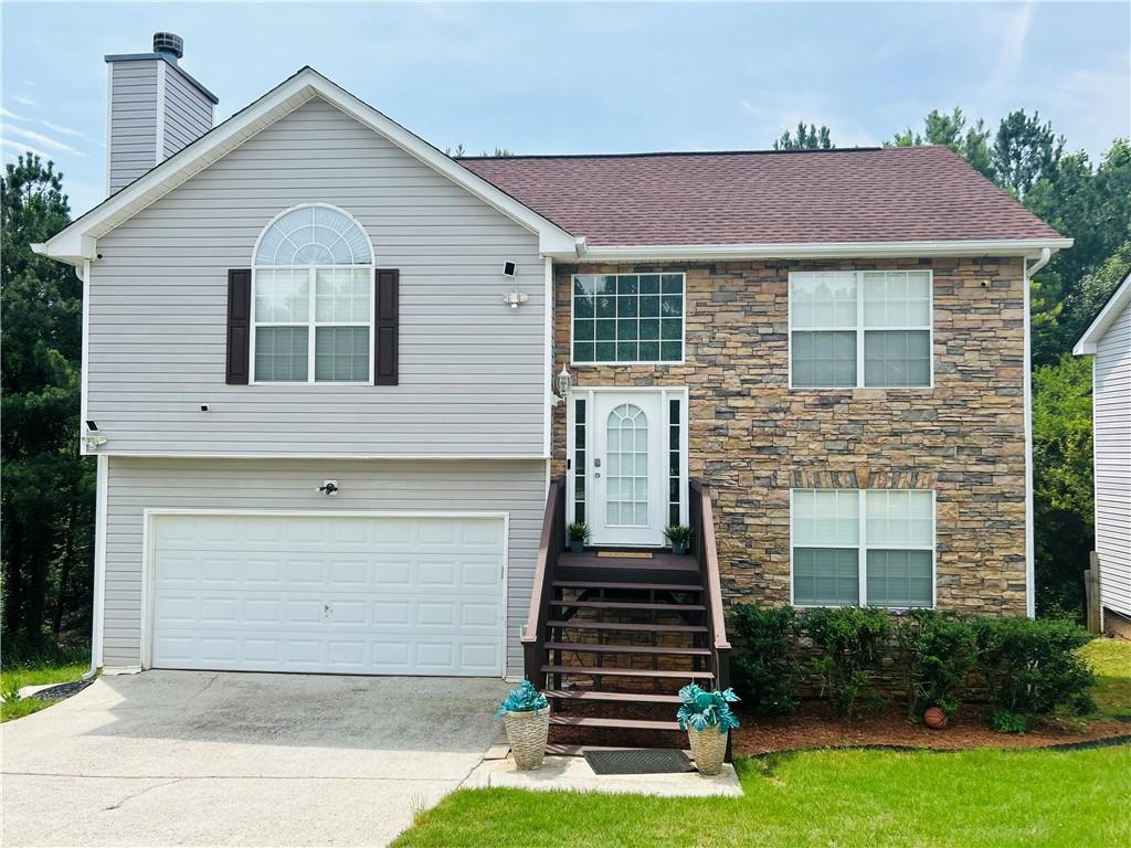 a front view of a house with a yard and garage