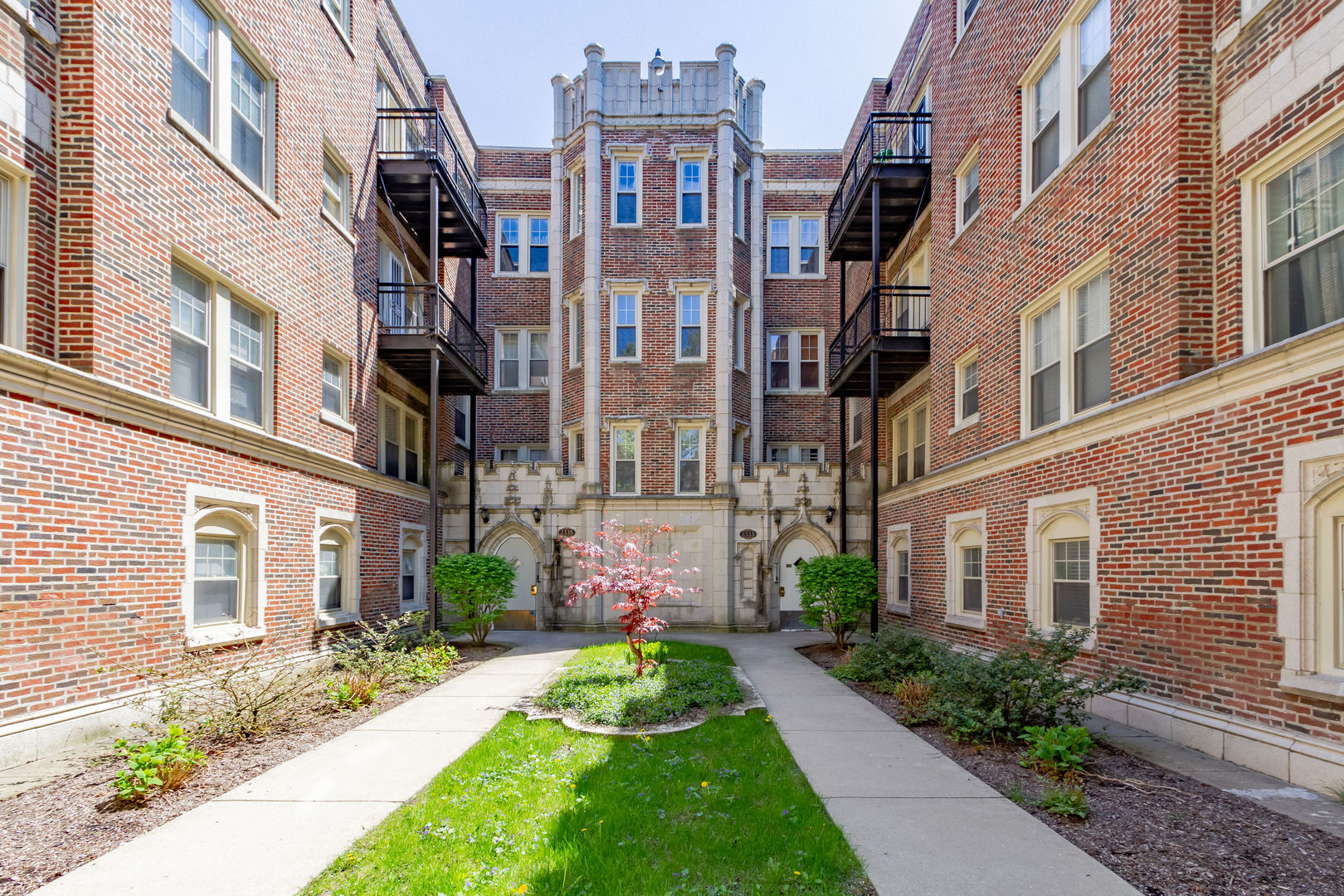 a view of a brick building next to a yard