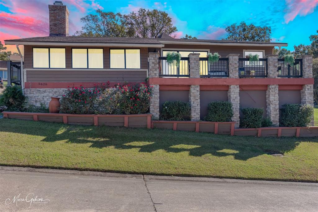 a large brick building with a yard in front of it