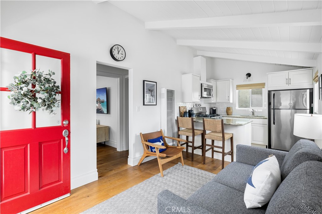 a living room with furniture a rug and a window