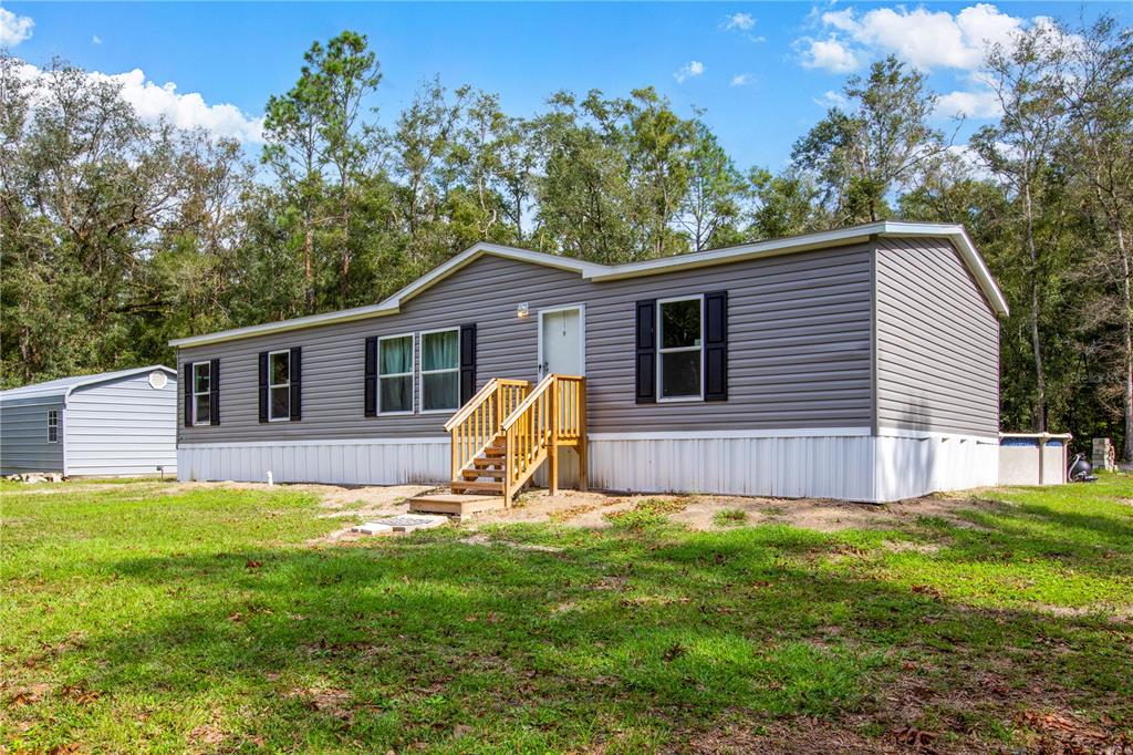 a view of a house with a yard and deck