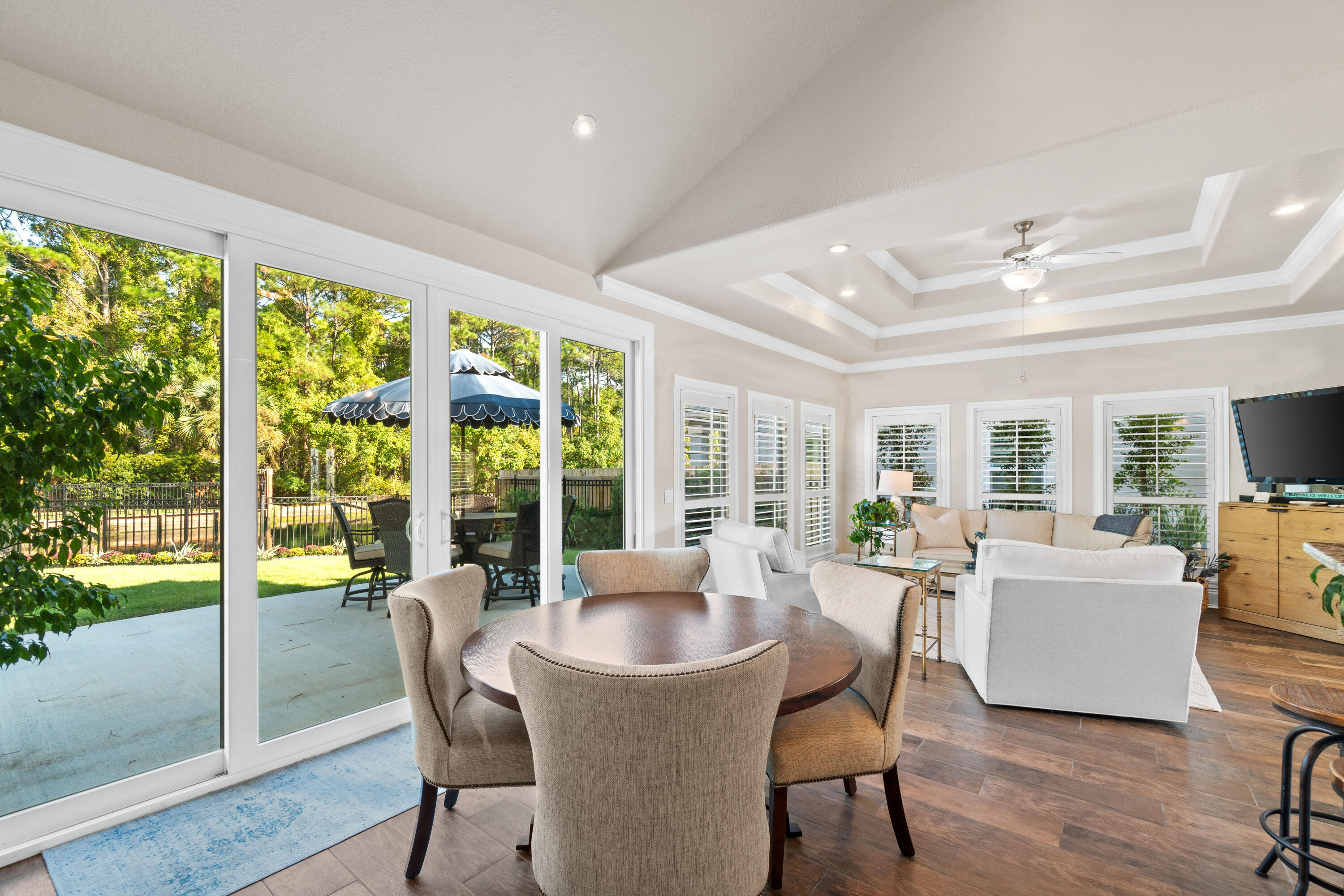 a dining room with furniture window and wooden floor