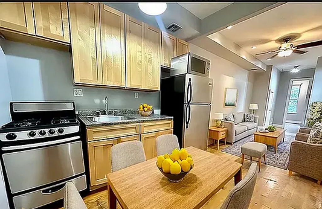 a kitchen with stainless steel appliances a stove a refrigerator and cabinets