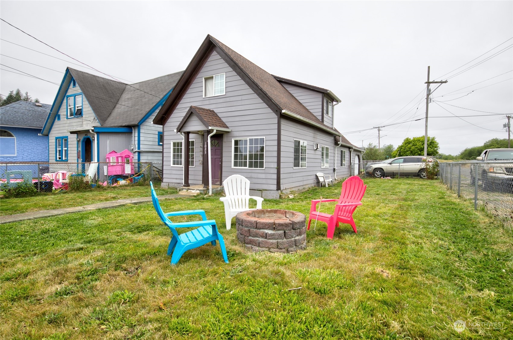 a backyard of a house with table and chairs