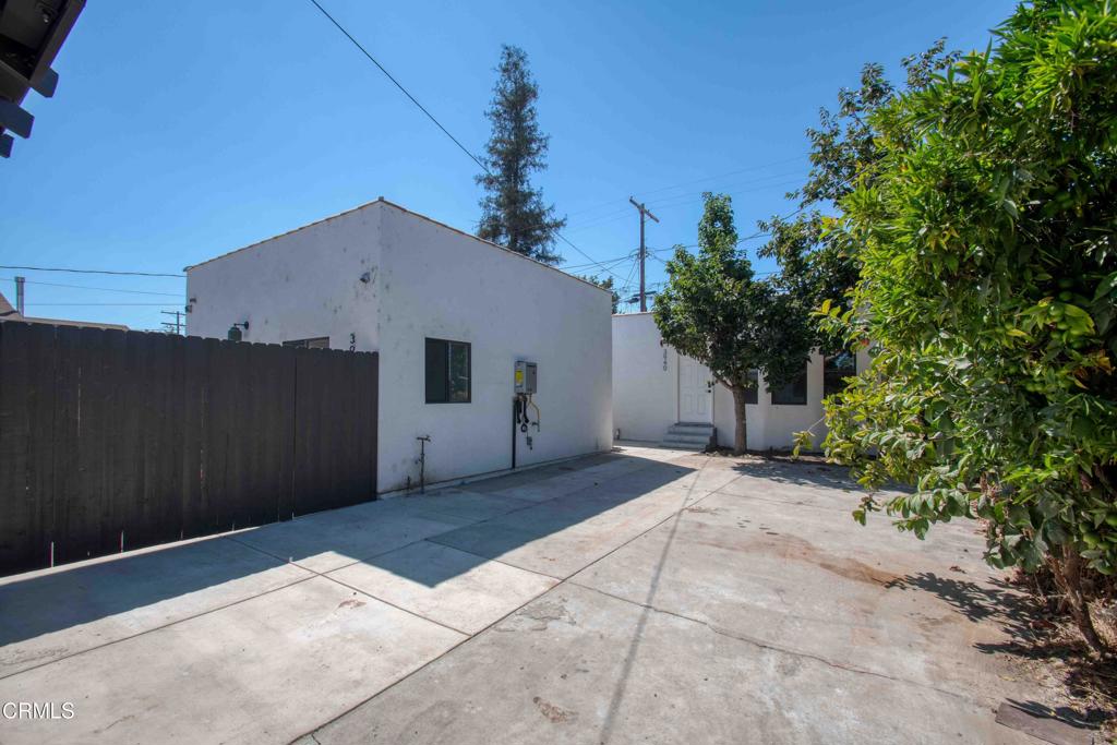 a backyard of a house with plants and trees