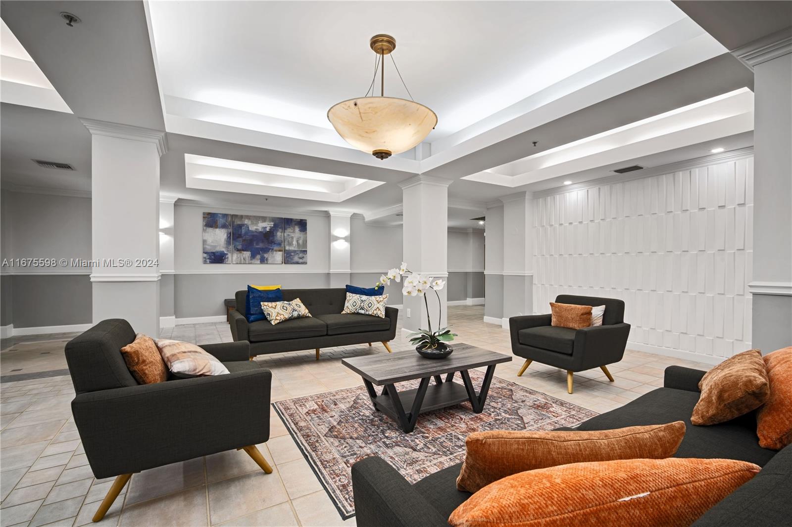 a living room with furniture kitchen view and a chandelier