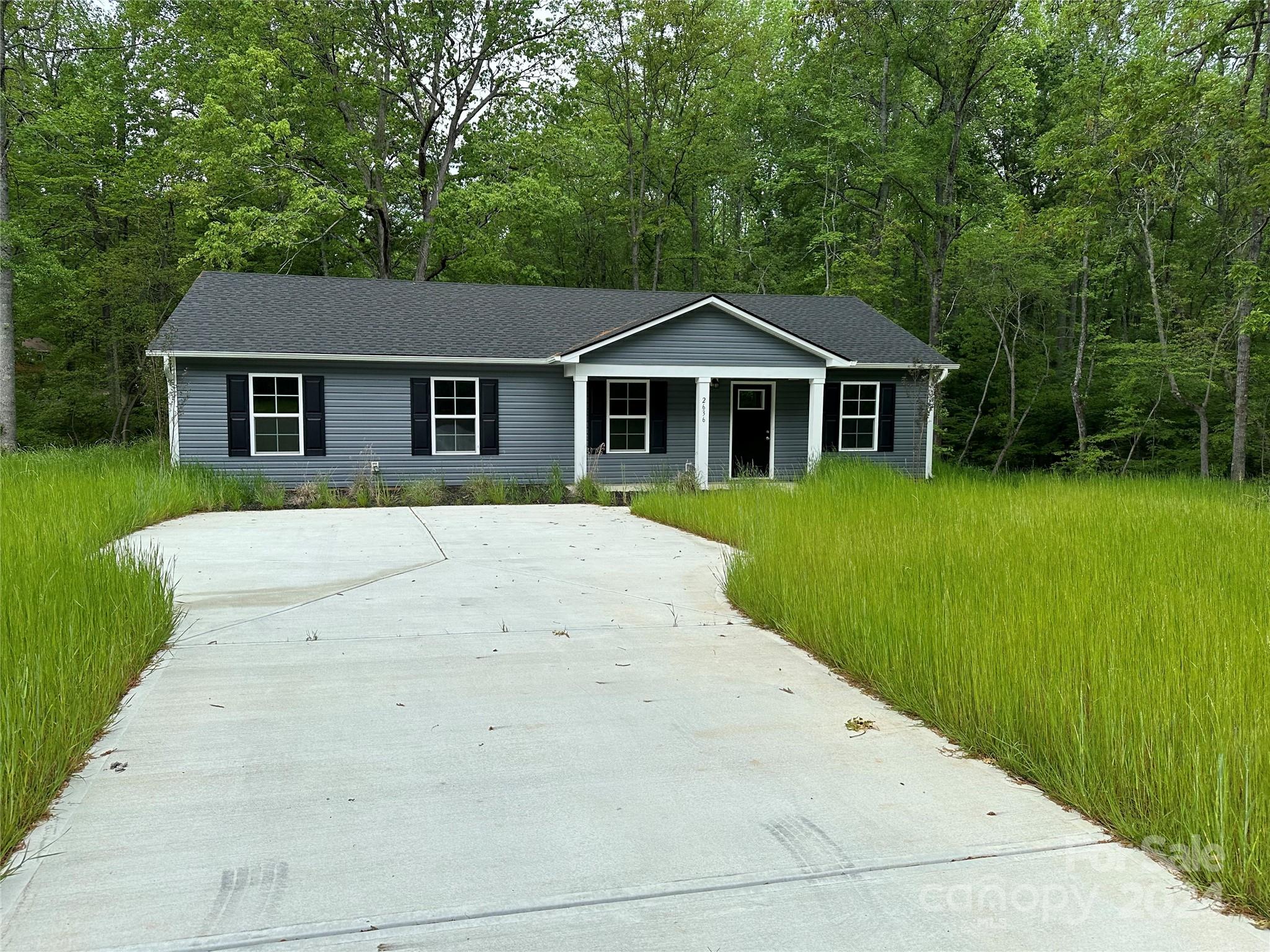 a view of a house with a backyard