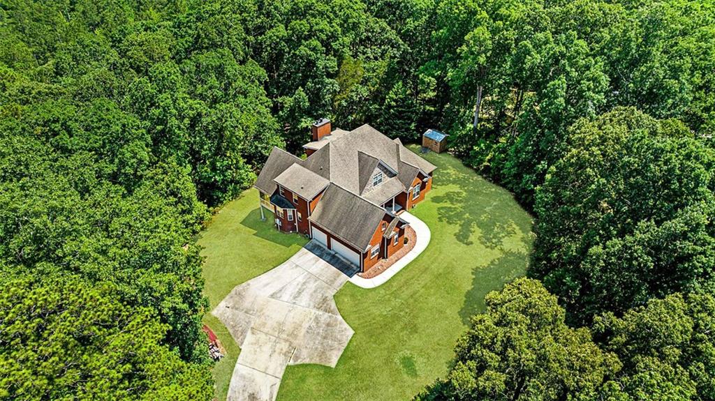 an aerial view of a house with a yard