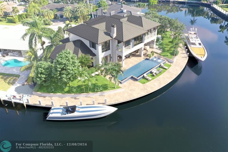 an aerial view of a house with a swimming pool