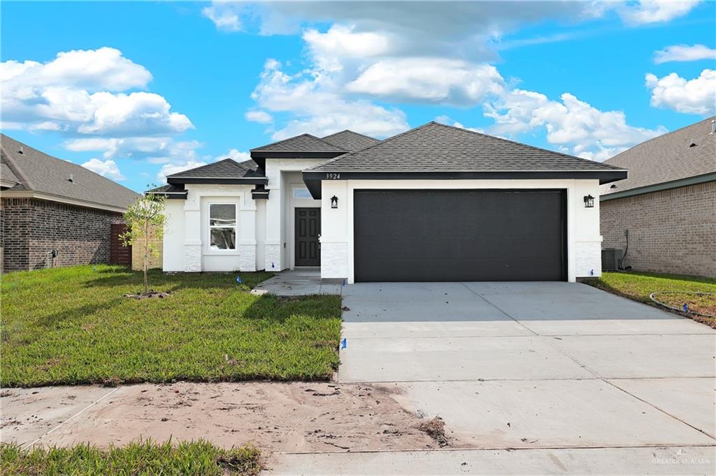 a front view of a house with a yard and garage