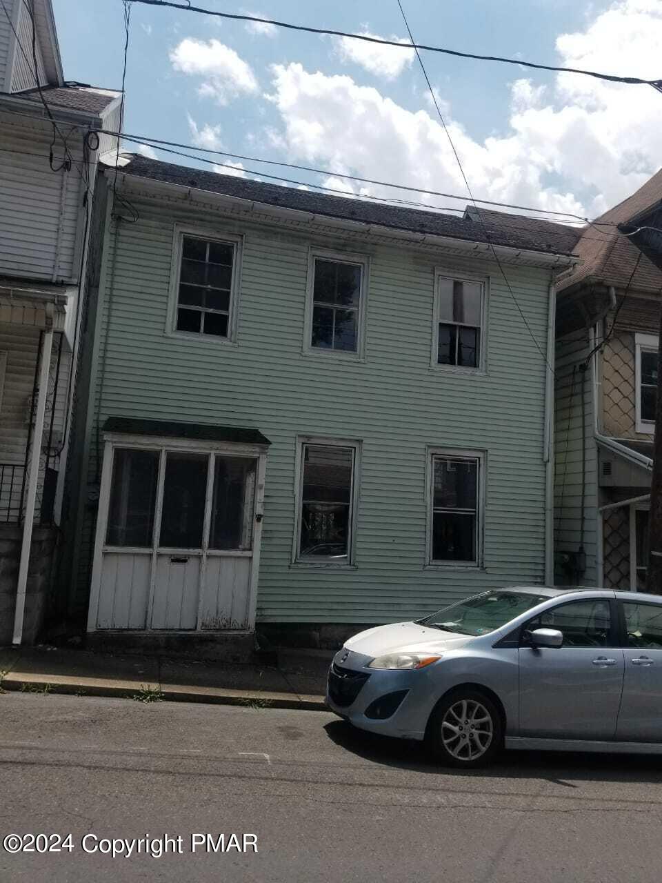 a front view of a house with parking space